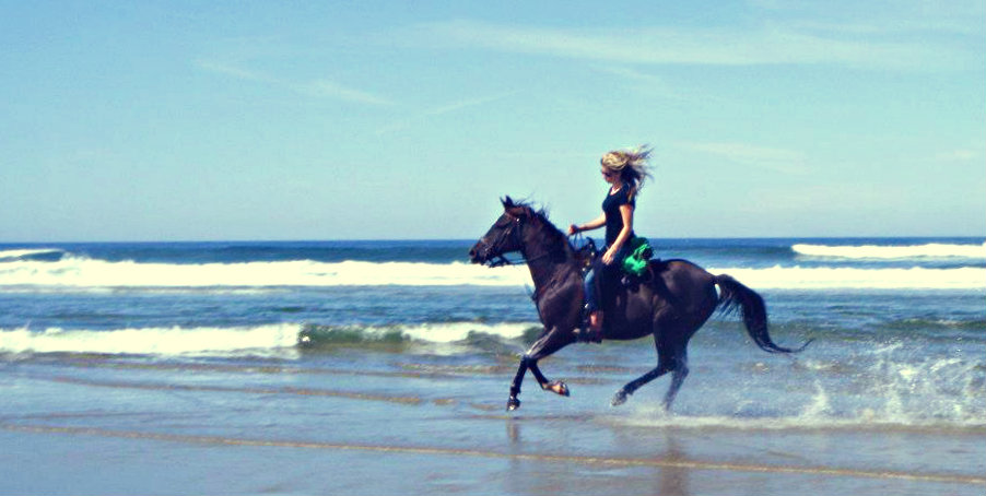 riding horses on the beach in Oregon